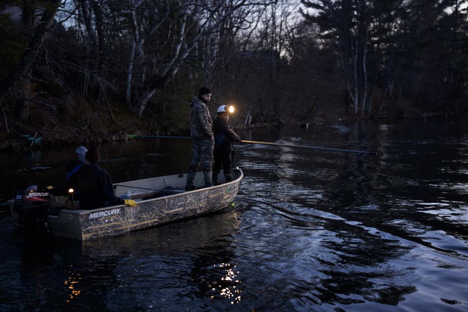 Ganebik Johnson, 13, second from right, teaches spearfishing on Pokegama Lake during a youth spearfishing event Saturday, April 20, 2024, in Lac Du Flambeau, Wis. (AP Photo/John Locher)