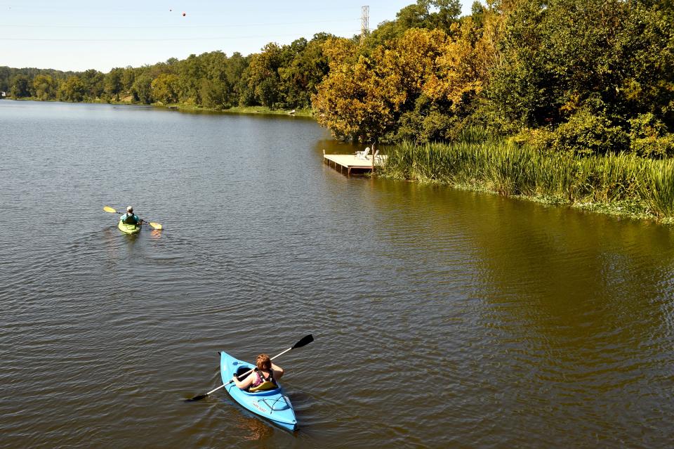 Kayakers take advantage of the beautiful fall weather as they row around Lake Olmstead on the first day autumn in September 2019.