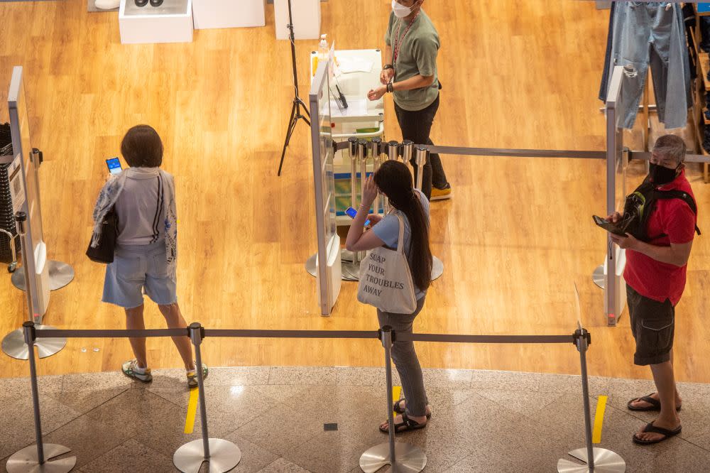 Patrons line up as they wait to enter one of the stores at a shopping mall in Kuala Lumpur September 10, 2021. — Picture by Shafwan Zaidon