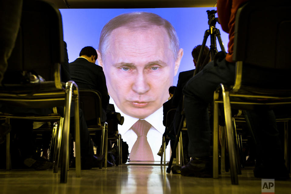 <p>Journalists watch as Russian President Vladimir Putin gives his annual state of the nation address in Manezh in Moscow, Russia. Putin set a slew of ambitious economic goals, vowing to boost living standards, improve health care and education and build modern infrastructure in a state-of-the-nation address. (AP Photo/Alexander Zemlianichenko) </p>