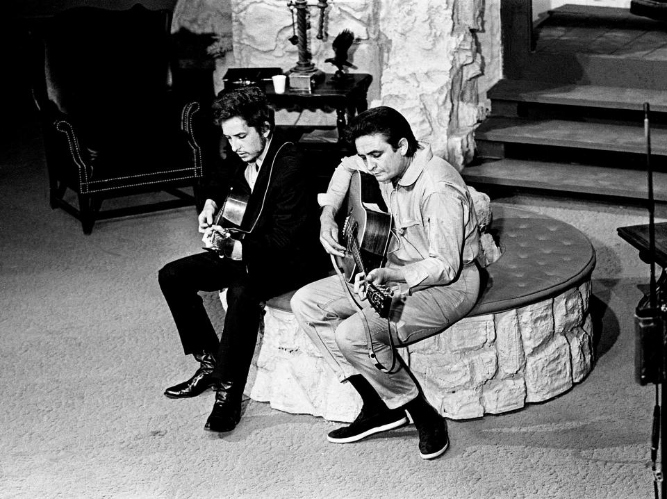 Host Johnny Cash, right, rehearses the song 