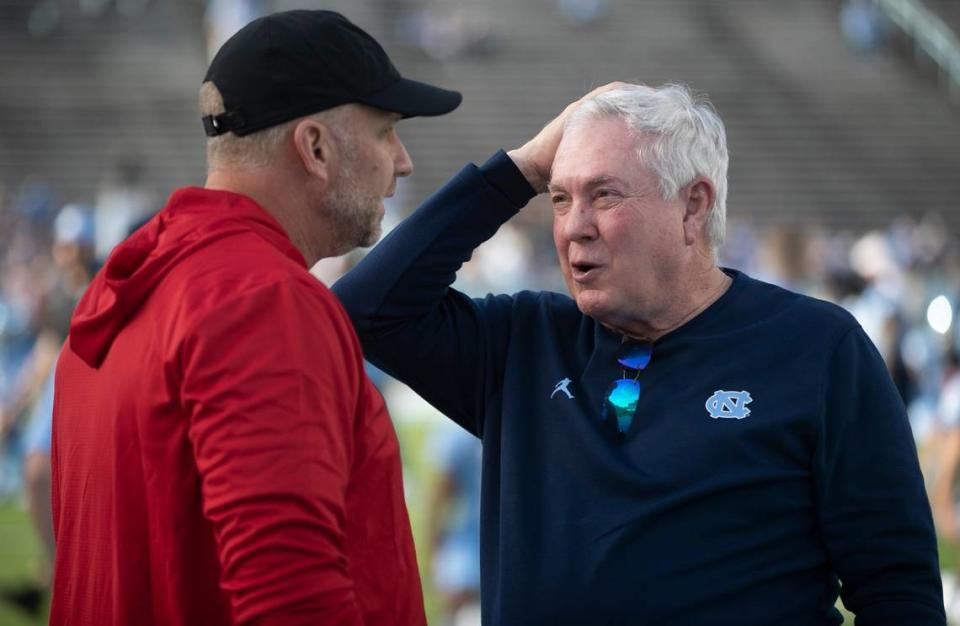 North Carolina coach Mack Brown talks N.C. State coach Dave Doeren prior to their game on Friday, November 25, 2022 at Kenan Stadium in Chapel Hill, N.C.