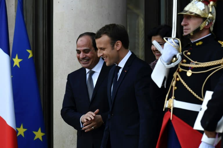 French President Emmanuel Macron leads Egyptian President Abdel Fattah al-Sisi at the Elysee Palace in Paris on October 24, 2017
