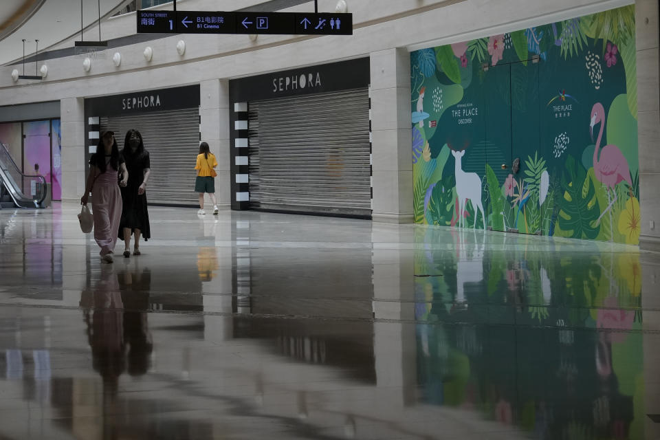 Women walk past shuttered and vacant shops at a shopping mall in Beijing on Thursday, July 27, 2023. Chinese leader Xi Jinping’s government is promising to drag the economy out of a crisis of confidence aggravated by tensions with Washington, wilting exports, job losses and anxiety among foreign companies about an expanded anti-spying law.(AP Photo/Andy Wong)