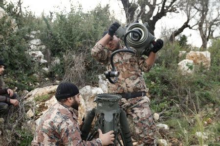 Rebel fighters prepare to launch an anti-tank missile towards forces loyal to Syria's President Bashar al-Assad in the Jabal al-Akrad area in Syria's northwestern Latakia province November 25, 2014. REUTERS/Alaa Khweled