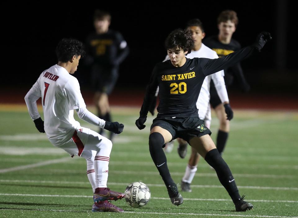 St. X's Alvaro Gonzalez goes around Butler's Daniel Gutierrez in the second half.  St. X defeated Butler 5-0 to advance in the KHSAA State Tournament and will play again on Saturday.  Gonzalez had three goals in the match.