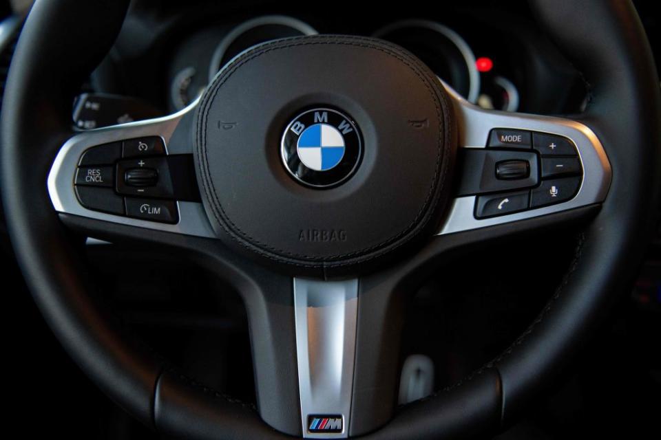 The BMW logo is seen on the steering wheel of a car at a BMW car dealership in Beijing.