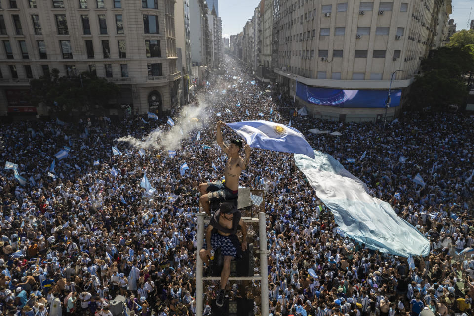 Argentine soccer fans descend on the capital's Obelisk to celebrate their team's World Cup victory over France, in Buenos Aires, Argentina, Sunday, Dec. 18, 2022. (AP Photo/Rodrigo Abd)