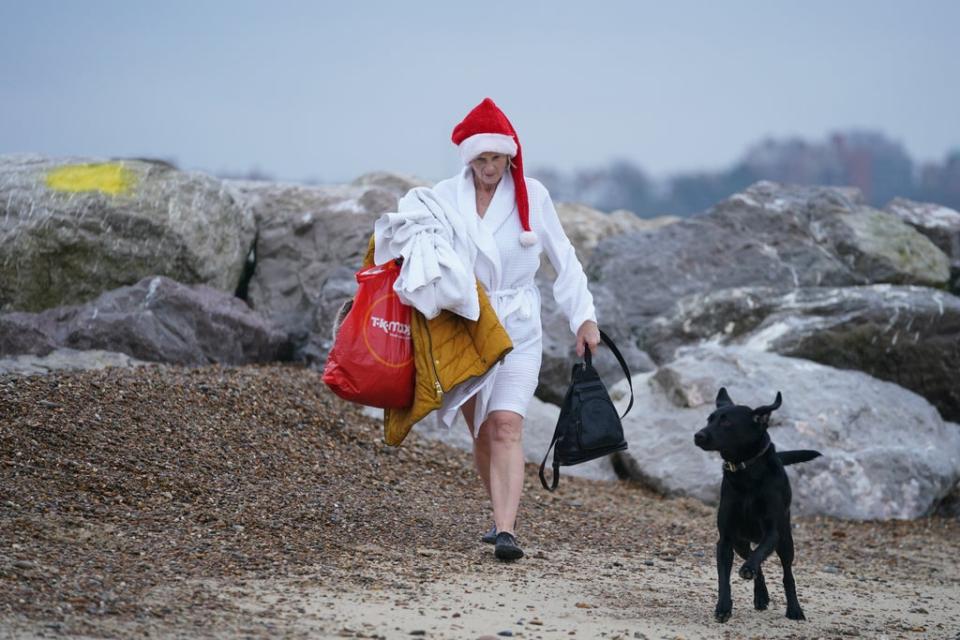 Dressed for the occasion… a woman walks along the beach (Joe Giddens/PA) (PA Wire)