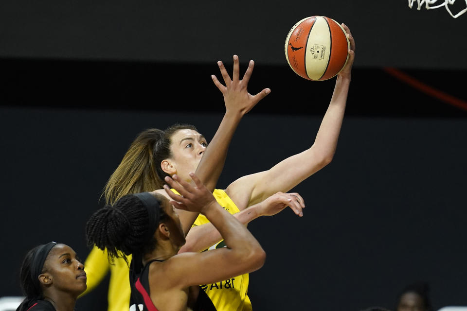 Seattle Storm forward Breanna Stewart (30) shoots over Las Vegas Aces guard Jackie Young and center A'ja Wilson during the second half of Game 1 of basketball's WNBA Finals Friday, Oct. 2, 2020, in Bradenton, Fla. (AP Photo/Chris O'Meara)