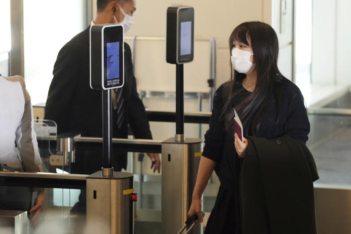 Japan's former Princess Mako, the elder daughter of Crown Prince Akishino, waits for her husband Kei Komuro, not in picture at a boarding gate to board an airplane to New York Sunday, Nov. 14, 2021, at Tokyo International Airport in Tokyo. (AP Photo/Eugene Hoshiko)