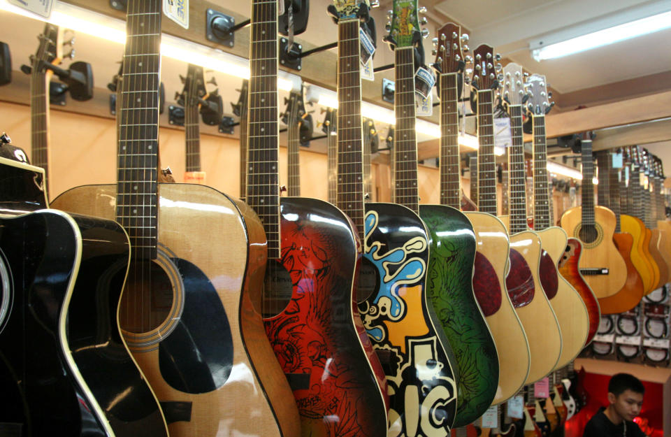 Guitars are on display at a musical instrument shop in Bangkok, Thailand, Friday, March 8, 2013. Delegates attending a global biodiversity conference in Bangkok this week are debating a U.S. proposal to streamline international customs checks for travelers with musical instruments that legally contain endangered wildlife products like exotic hardwoods, ivory or tortoise shell. (AP Photo/Sakchai Lalit)