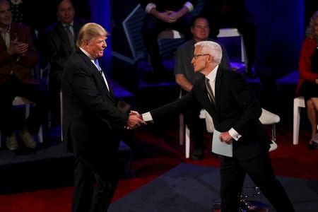 Republican U.S. Presidential candidate Donald Trump shakes hands with CNN anchor Anderson Cooper at the CNN Town Hall at Riverside Theater in Milwaukee, Wisconsin March 29, 2016. REUTERS/Ben Brewer