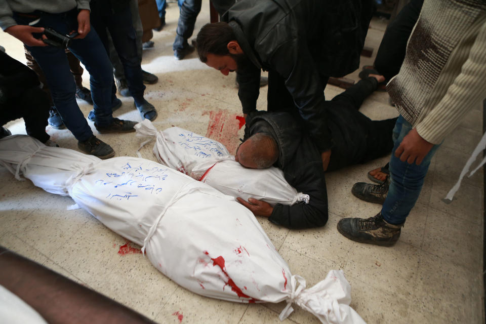 A Syrian man grieves over the body of his son following a reported airstrike in the rebel-controlled town of Arbin, in the eastern Ghouta region on the outskirts of the capital Damascus, on Dec. 3, 2017. (Photo:Abudlmonam Eassa/AFP/Getty Images)