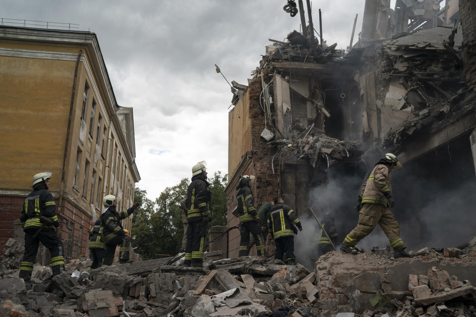 Firefighters work to extinguish a fire as they look for potential victims after a Russian attack that heavily damaged a residential building in Sloviansk, Ukraine, Wednesday, Sept. 7, 2022. (AP Photo/Leo Correa)