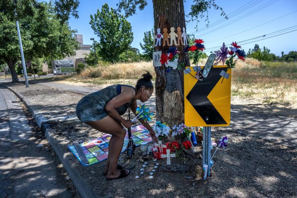 Skye Massengale brings flowers and pinwheels in June to the scene of the collison on San Juan Road where Rayshawna Armstrong and two children died and eight other people were injured. 