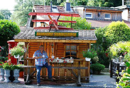 Gary Blackburn, a 53-year-old tree surgeon from Lincolnshire, Britain, is having tea time with typical British short bread at his British curiosities collection called "Little Britain" in Linz-Kretzhaus, south of Germany's former capital Bonn, Germany, August 24, 2017. REUTERS/Wolfgang Rattay