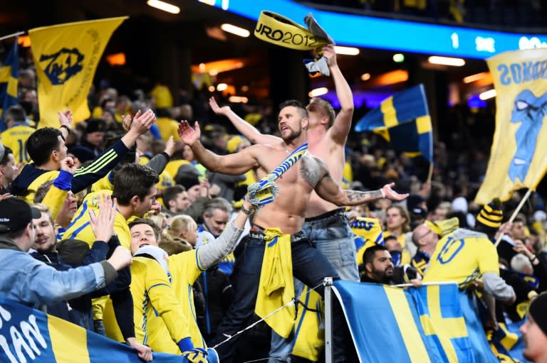 Swedish fans cheer after their team's victory in their FIFA World Cup 2018 qualification football match against Italy in Solna, Sweden on November 10, 2017