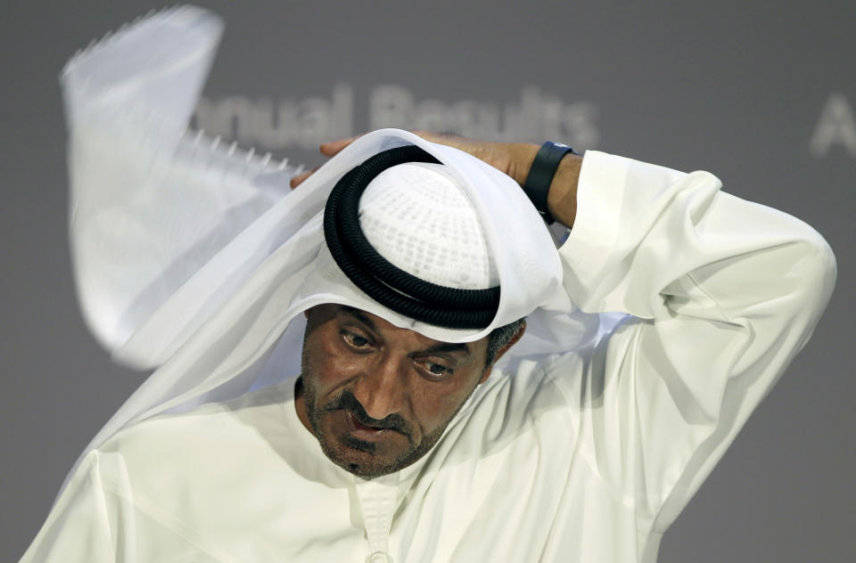 Sheik Ahmed bin Saeed Al Maktoum, Emirates' chairman and CEO, fixes his Ghutra, a traditional men's head scarf, during a news conference in Dubai, United Arab Emirates, Thursday, May 8, 2014. The parent company of the Middle East's biggest airline, Emirates, posted an annual profit Thursday of $1.1 billion as it enjoyed a dip in fuel costs and boosted capacity with the addition of two dozen new planes. (AP Photo/Kamran Jebreili)
