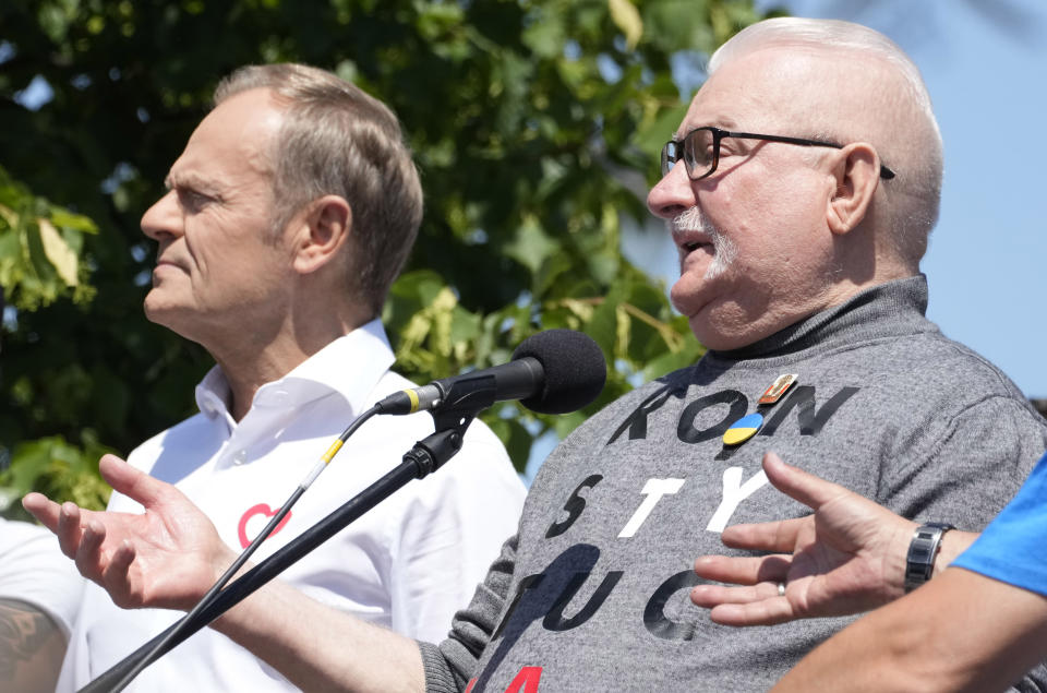 Centrist opposition party leader Donald Tusk, left, and Lech Walesa, who along with other critics accuses the government of eroding democracy, lead an anti-government march in Warsaw, Poland, Saturday June 4, 2023. The march is being held on the 34th anniversary of the first democratic elections in 1989 after Poland emerged from decades of communist rule. (AP Photo/Czarek Sokolowski)