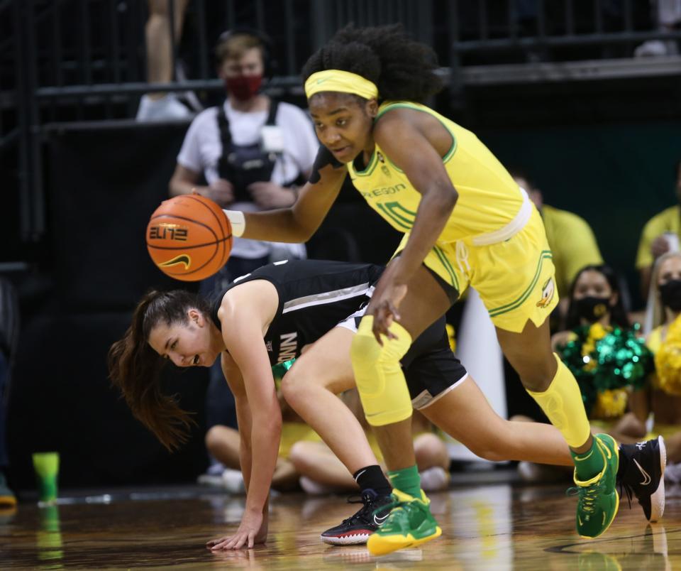 Oregon's Chanaya Pinto, right, forces a turnover against UConn's  Caroline Ducharme during the second half Jan. 17, 2022.