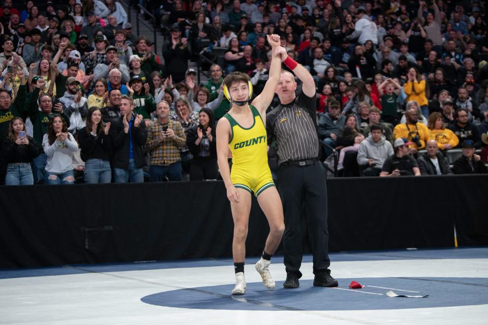 Pueblo County's Zion Mares has his hand raised as the winner of the 113-pound championship during the Class 4A state wrestling tournament at Ball Arena on Saturday, Feb. 18, 2023.