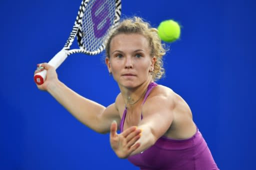 Katerina Siniakova of Czech Republic in action against Elise Mertens of Belgium during their first round women's singles match at the Wuhan Open tennis tournament