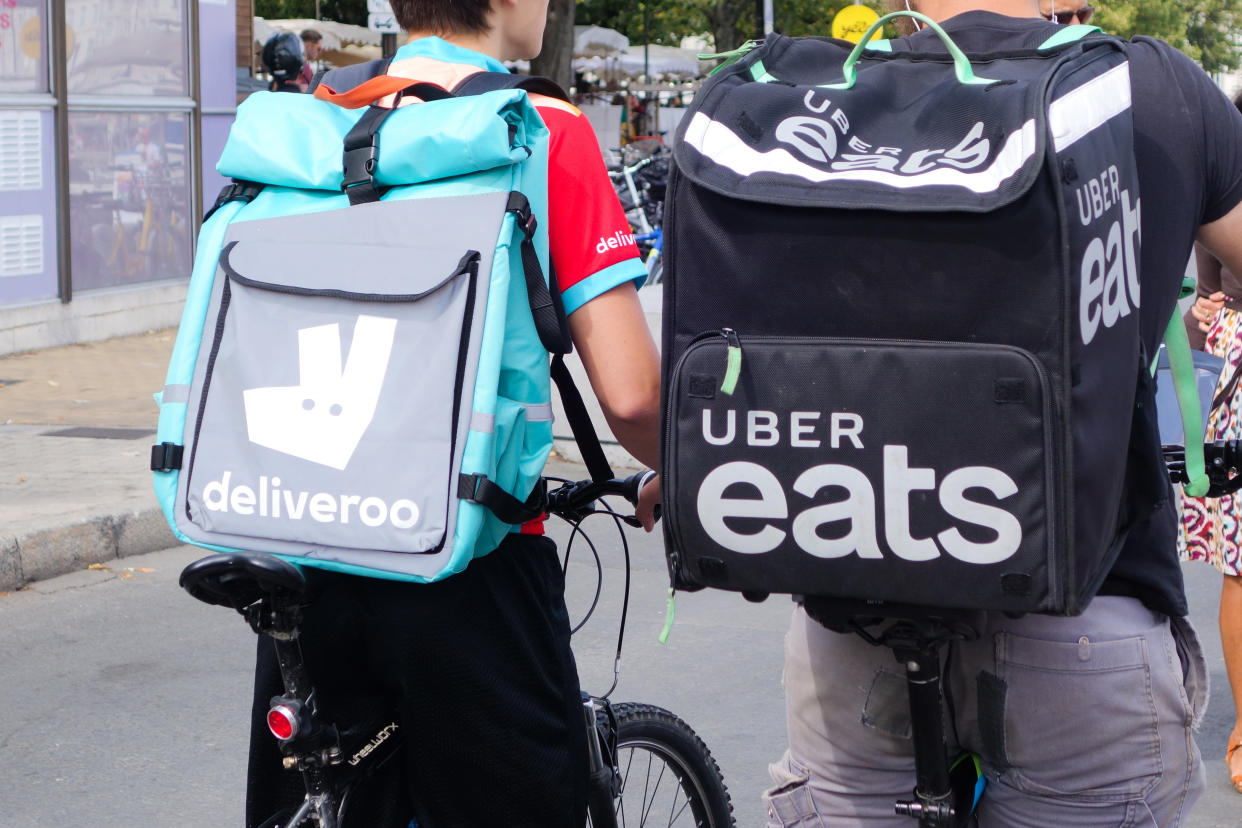 Deliveroo and Uber Eats delivery men. (Photo by: Andia/Universal Images Group via Getty Images)