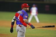Puerto Rico's Yadier Molina walk to first base after hit by pitch during the first inning of the team's' Caribbean Series baseball final game against the Dominican Republic at Teodoro Mariscal stadium in Mazatlan, Mexico, Saturday, Feb. 6, 2021. (AP Photo/Moises Castillo)