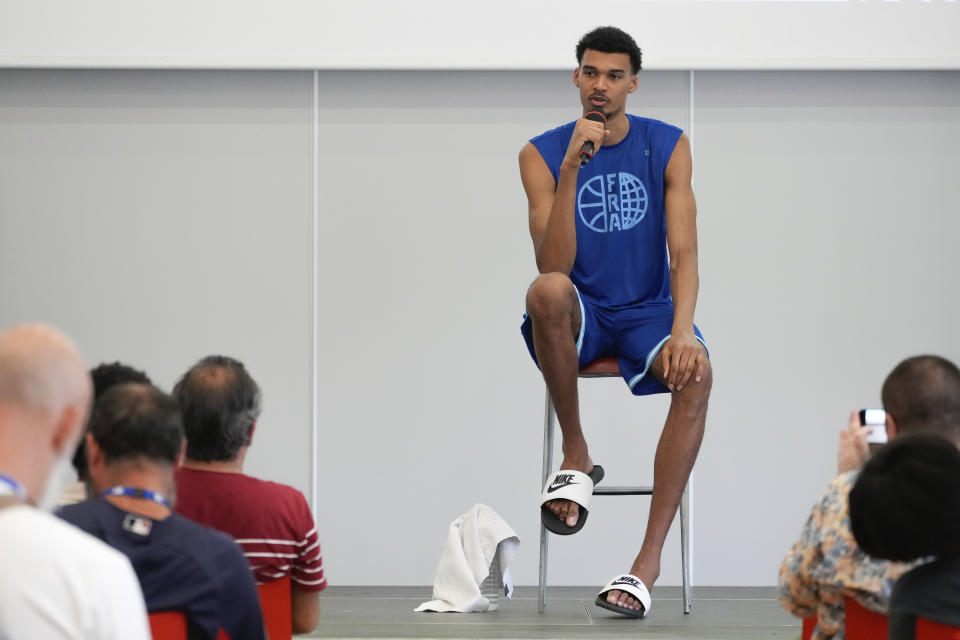 France's basketball player Victor Wembanyama, who plays for the NBA San Antonio Spurs, speaks during media day at the French National Institute of Sport and Physical Education, in Vincennes, outside Paris, Thursday, June 27, 2024. (AP Photo/Thibault Camus)