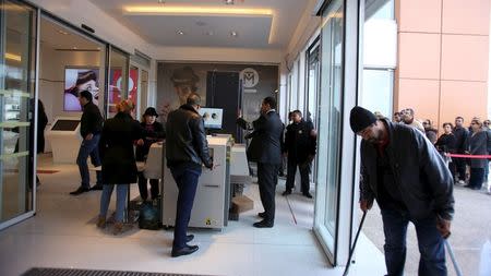 Security screen the bags of people entering the Tunisia Mall in Berges du Lac in Tunis, Tunisia, December 20, 2015. REUTERS/Zoubeir Souissi