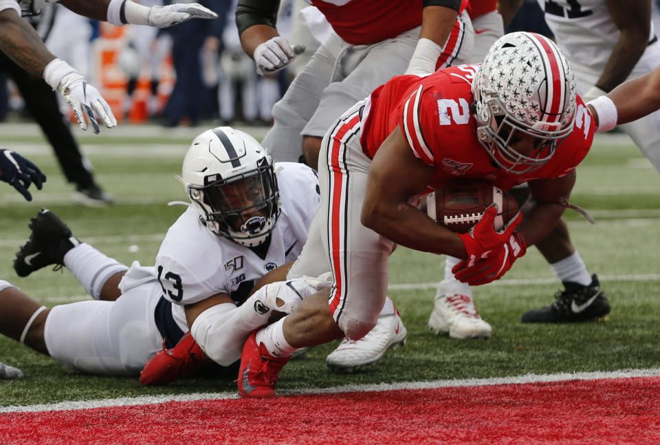 Ohio State running back J.K. Dobbins, right, drags Penn State linebacker Ellis Brooks into the end zone for a score during the first half of an NCAA college football game Saturday, Nov. 23, 2019, in Columbus, Ohio. (AP Photo/Jay LaPrete)