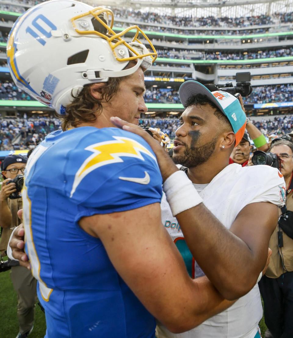 Chargers quarterback Justin Herbert and Dolphins quarterback Tua Tagovailoa embrace after the game.