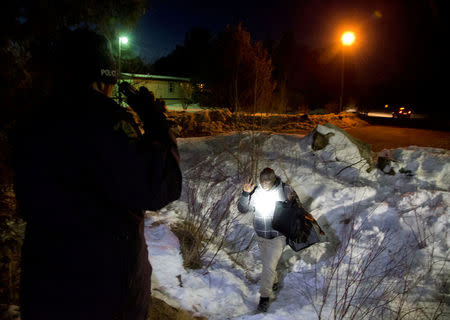 A man who claimed to be from Sudan, who kept saying "I just want to be safe", is confronted by a Royal Canadian Mounted Police (RCMP) officer as he illegally crosses the U.S.-Canada border leading into Hemmingford, Quebec, Canada, March 20, 2017. REUTERS/Christinne Muschi/File Photo