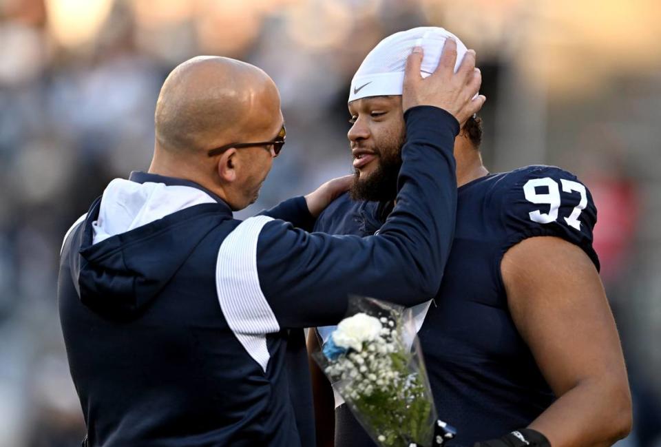 Penn State football coach James Franklin talks to senior PJ Mustipher before the game against Michigan State on Saturday, Nov. 26, 2022.