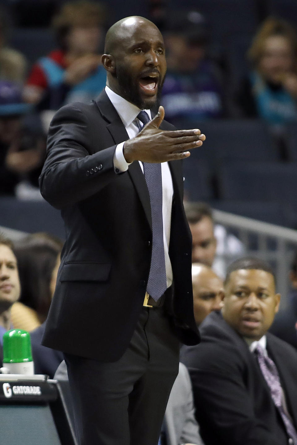 Atlanta Hawks' head coach Lloyd Pierce makes a call from the bench against the Charlotte Hornets during the first half of an NBA basketball game in Charlotte, N.C., Sunday, Dec. 8, 2019. (AP Photo/Bob Leverone)