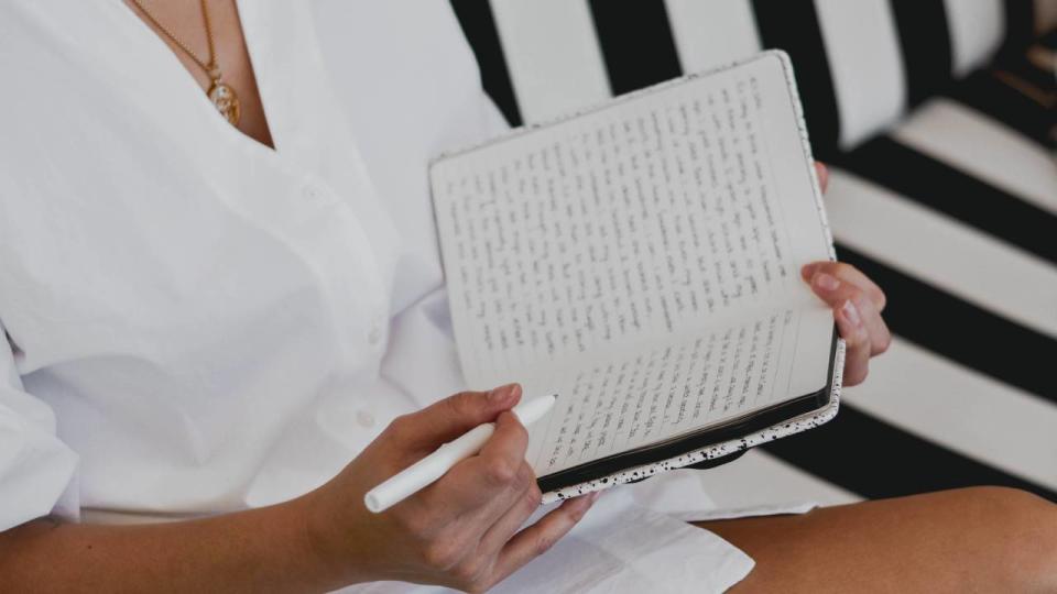 Woman writing in a journal