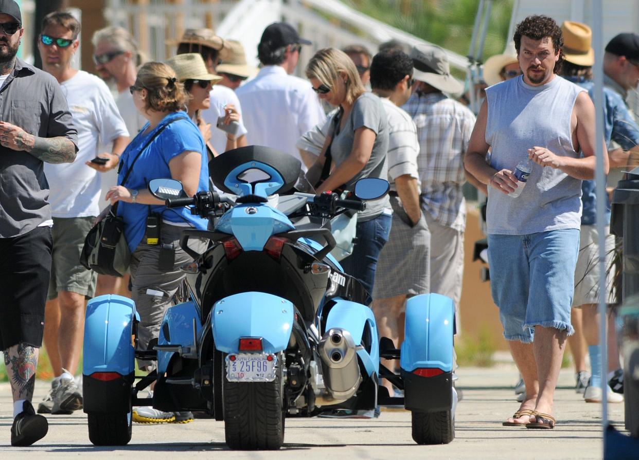 Eastbound & Down star Danny McBride, right, heads for an unusual motorcycle while filming a scene for the show in Carolina Beach in 2011. It's one of two Wilmington-shot shows on a list of top 10 TV shows set in North Carolina by a sports betting website.