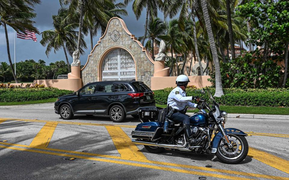 Local law enforcement officers outside the home of Donald Trump - AFP