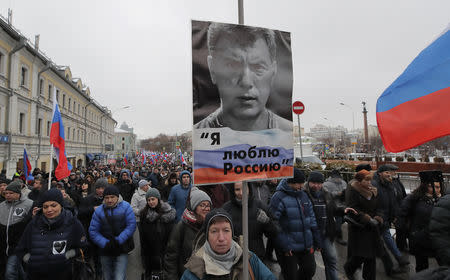 People attend a rally in memory of Russian opposition politician Boris Nemtsov, who was assassinated in 2015, in Moscow, Russia February 24, 2019. The placard reads "I love Russia". REUTERS/Maxim Shemetov