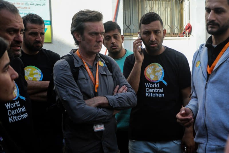 Staff members of World Central Kitchen wait at a hospital morgue in Rafah, in the southern Gaza Strip on Tuesday. Photo by Ismael Mohamad/UPI