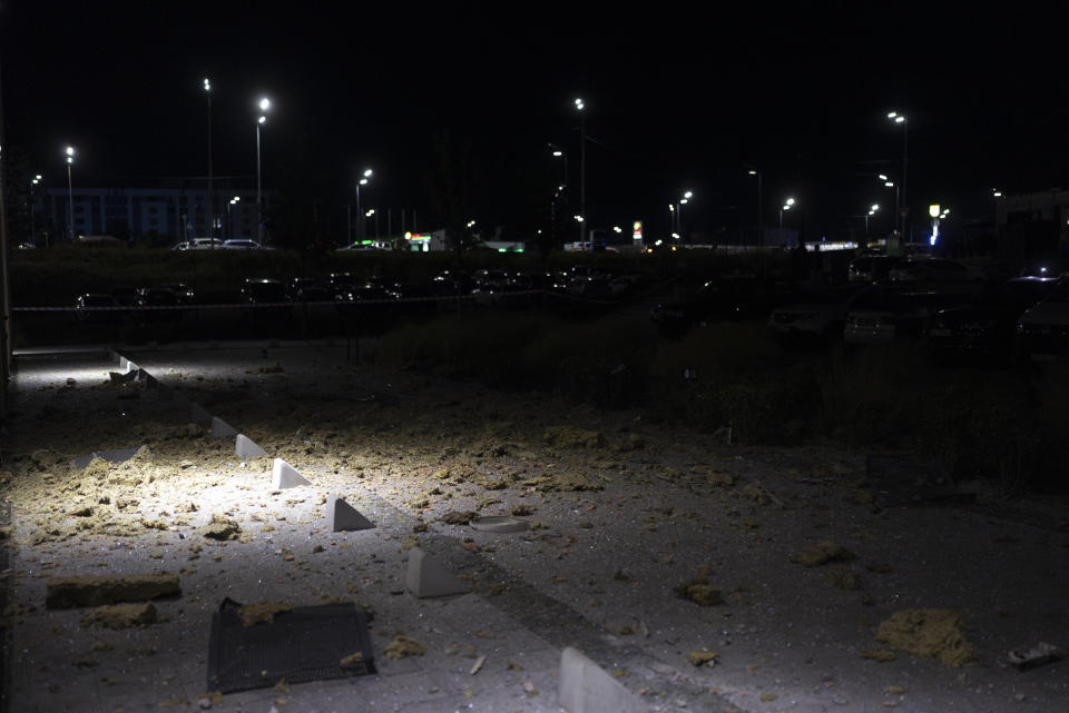 Fallen debris from a damaged apartment litters the ground outside the building in Kyiv, Ukraine, Thursday, July 13, 2023, following Russia's air attacks targeting the capital city. (AP Photo/Jae C. Hong)