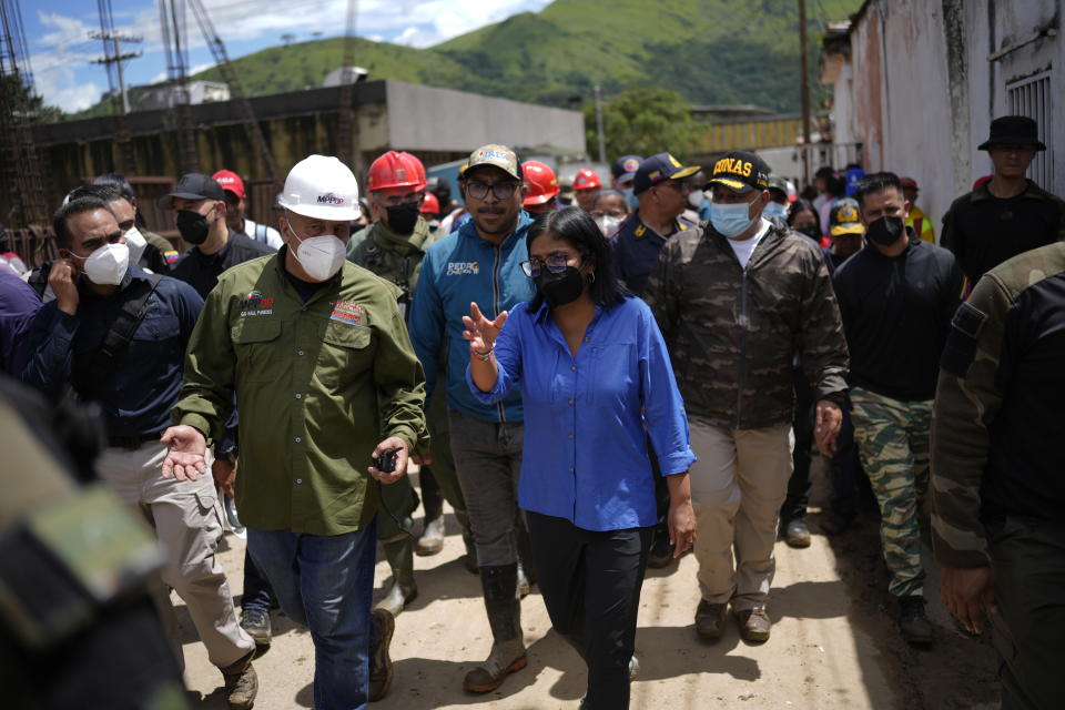 Vice President Delcy Rodriguez, center, visits the area flooded in Las Tejerias, Venezuela, Monday, Oct. 10, 2022. A fatal landslide fueled by flooding and days of torrential rain swept through this town in central Venezuela. (AP Photo/Matias Delacroix)