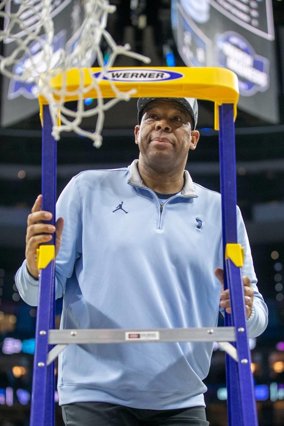 North Carolina coach Hubert Davis climbs the ladder to cut down the net following the Tar Heels’ 69-49 victory over Saint Peter’s in the NCAA East Regional Championship game on Sunday, March 27, 2022 at Wells Fargo Center in Philadelphia, Pa.