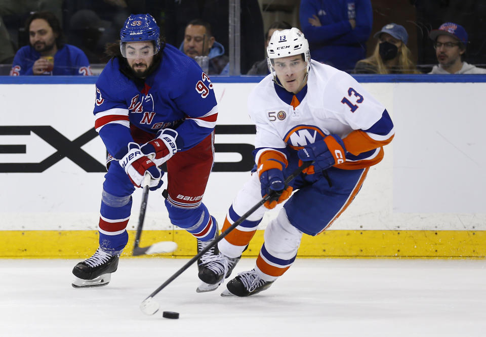 New York Islanders center Mathew Barzal skates with the puck as New York Rangers center Mika Zibanejad defends during the second period of an NHL hockey game Thursday, Dec. 22, 2022, in New York. (AP Photo/John Munson)