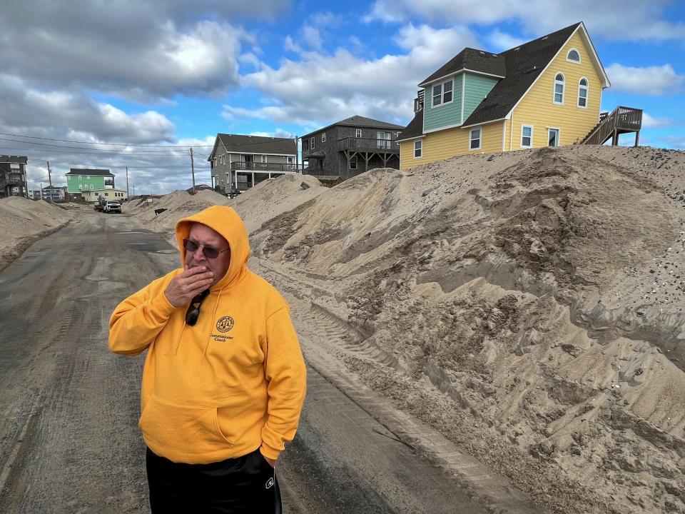 Dare County Commissioner Danny Couch stands on a recently cleared Ocean Drive on the Outer Banks in December 2022.