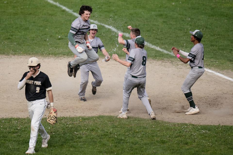 Oakmont's Ben Forbes leaps in the air after hitting a walk-off single in the bottom of the seventh to lift the Spartans past St. Paul on Monday.