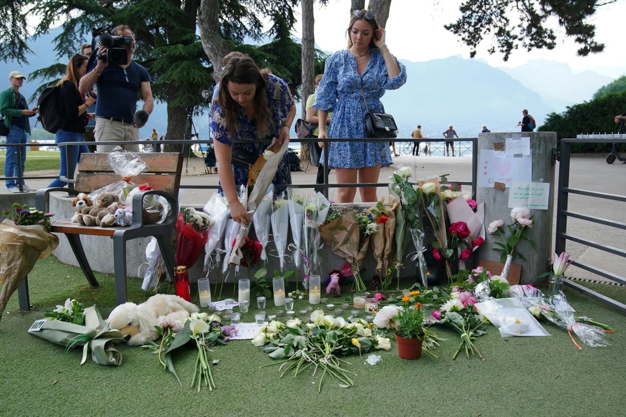 People are still leaving tributes near the scene at the lakeside park in Annecy (Peter Byrne/PA Wire)