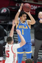 UCLA guard Jules Bernard (1) shoots as Utah guard Rylan Jones (15) defends during the second half of an NCAA college basketball game Thursday, Feb. 25, 2021, in Salt Lake City. (AP Photo/Rick Bowmer)