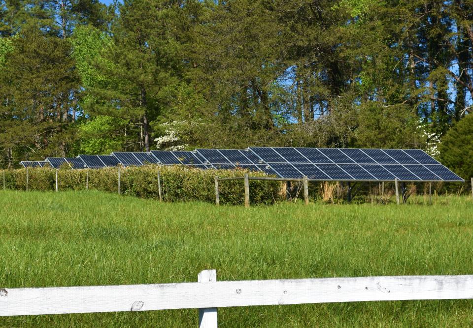 Seven banks of solar panels feed power to power the pump that keeps water flowing through the garden stream, and supply the house at Betty and Walter Montgomery's home in Campobello SC. April 2022.